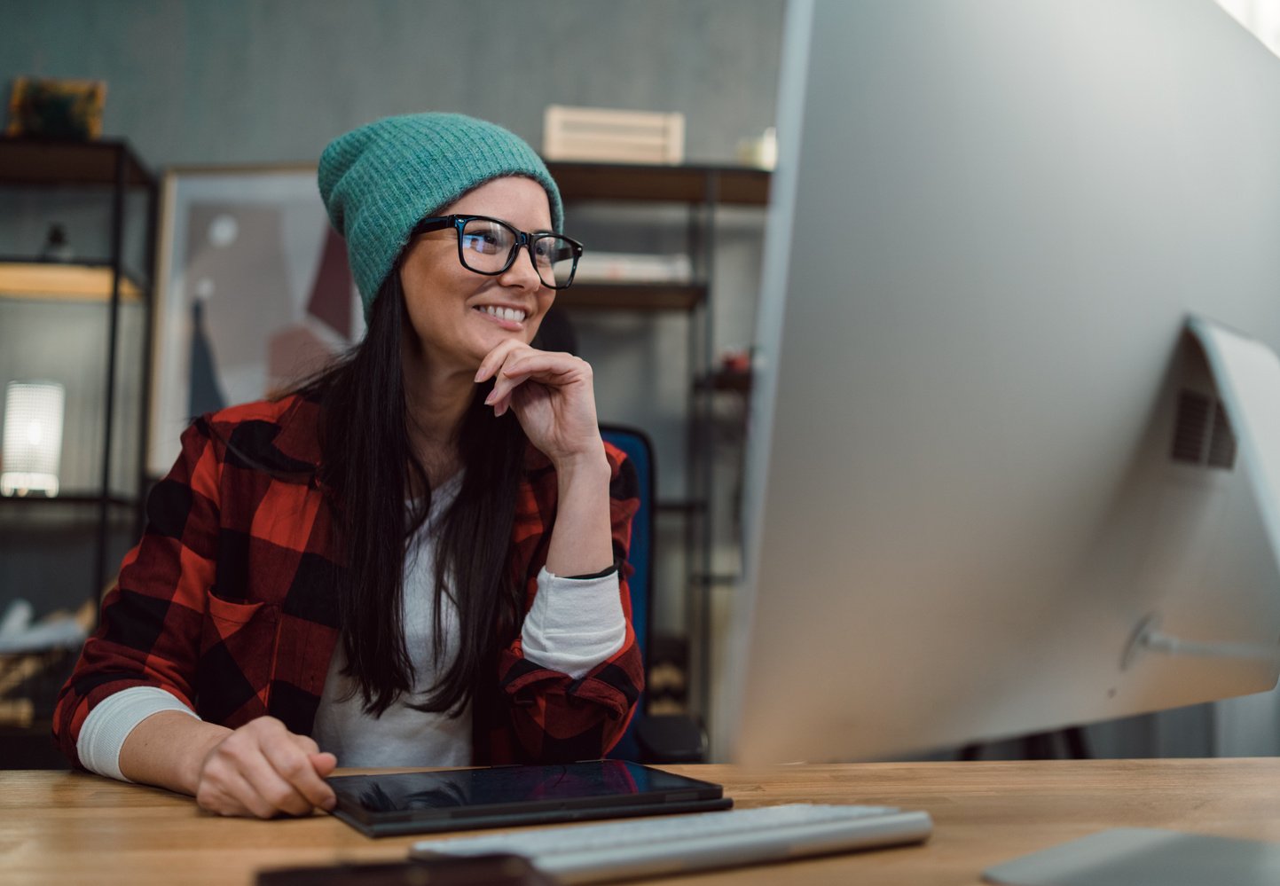 Happy Female Video Editor Works Indoors in Creative Office Studio.